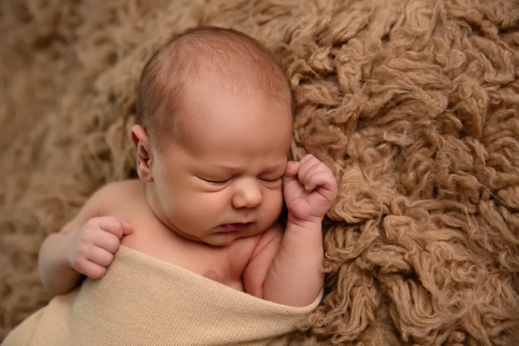 Gewickeltes Baby auf Braun